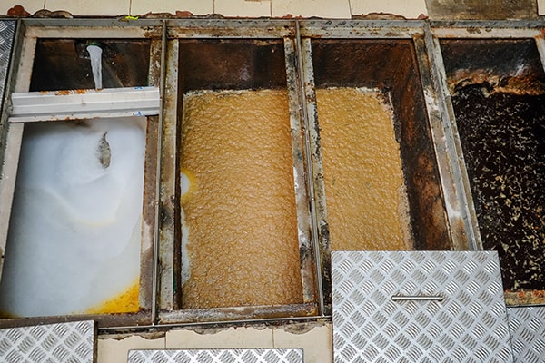 grease trap maintenance involves thoroughly cleaning the trap, removing grease and solids, and inspecting for any issues